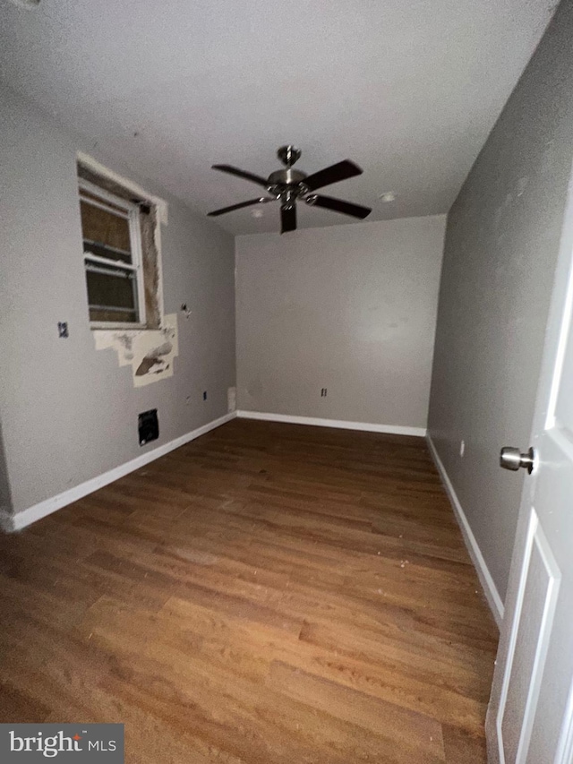 empty room with hardwood / wood-style floors, ceiling fan, and a textured ceiling