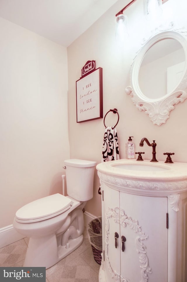 bathroom featuring tile patterned floors, vanity, and toilet