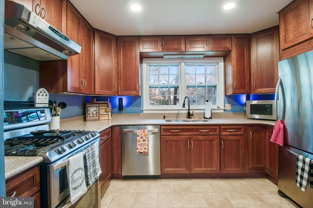 kitchen with sink, stainless steel appliances, and exhaust hood