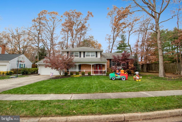 view of front of house with a front lawn, a porch, and a garage