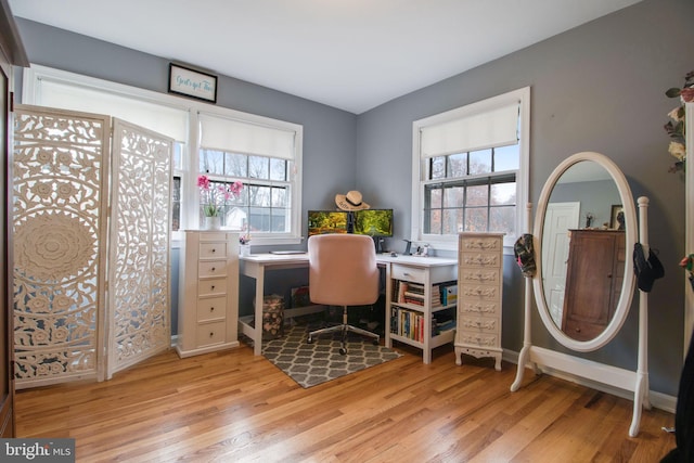 office space with light wood-type flooring and a wealth of natural light