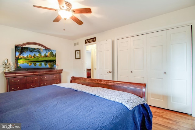 bedroom with ceiling fan, a closet, and light hardwood / wood-style floors