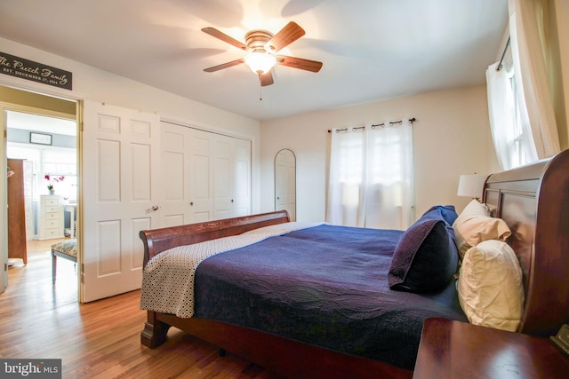 bedroom featuring ceiling fan, a closet, and light hardwood / wood-style flooring