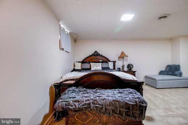 carpeted bedroom with ornamental molding