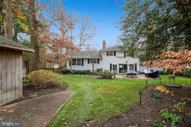 back of property featuring a lawn and a patio area