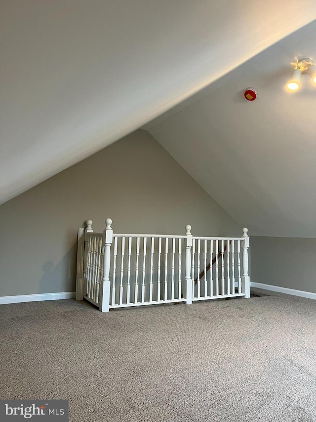 bonus room with carpet floors and vaulted ceiling