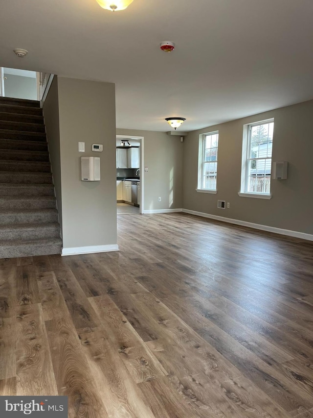 unfurnished living room with hardwood / wood-style flooring