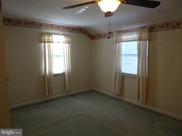 spare room with carpet floors, a wealth of natural light, and ceiling fan