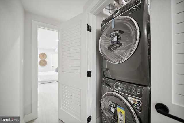 laundry area featuring stacked washer / drying machine