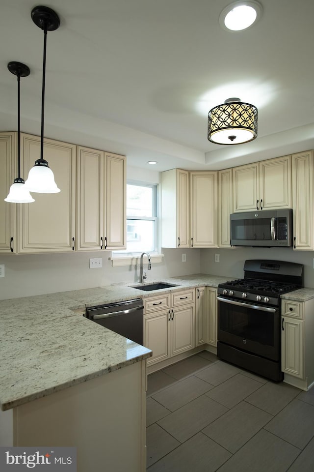 kitchen featuring light stone countertops, sink, hanging light fixtures, light tile patterned flooring, and appliances with stainless steel finishes