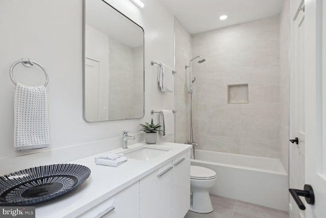 full bathroom with tile patterned flooring, vanity, toilet, and tiled shower / bath