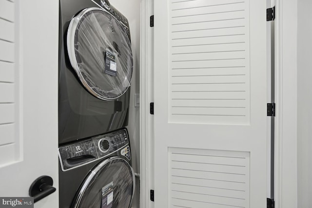 laundry area featuring stacked washer and dryer