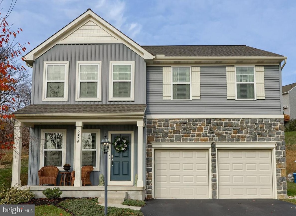 view of front property featuring a porch and a garage