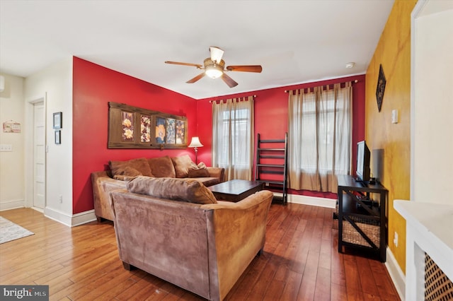 living room featuring ceiling fan and hardwood / wood-style floors