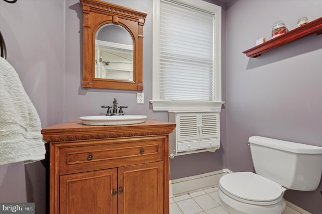 bathroom featuring tile patterned flooring, vanity, and toilet