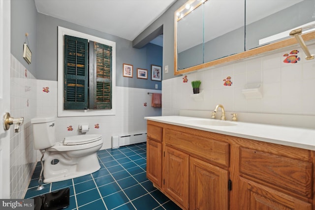 bathroom with tile patterned flooring, toilet, baseboard heating, and tile walls