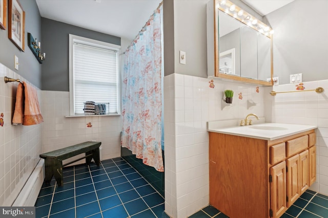 bathroom featuring tile patterned flooring, vanity, a baseboard radiator, and tile walls