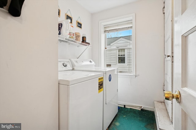 clothes washing area featuring separate washer and dryer and dark carpet