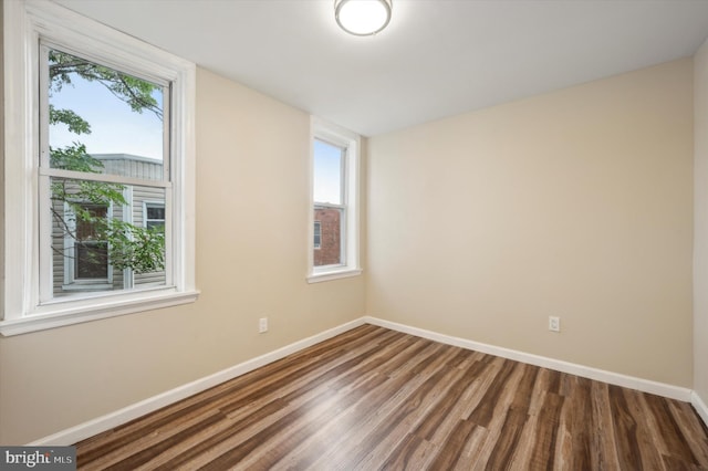 unfurnished room featuring hardwood / wood-style flooring and plenty of natural light