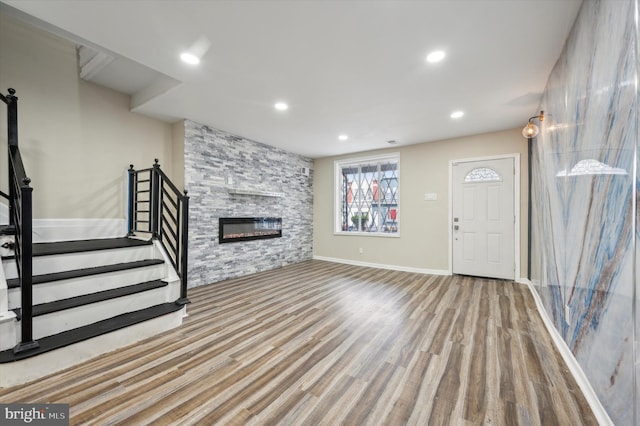 unfurnished living room featuring a fireplace and light wood-type flooring