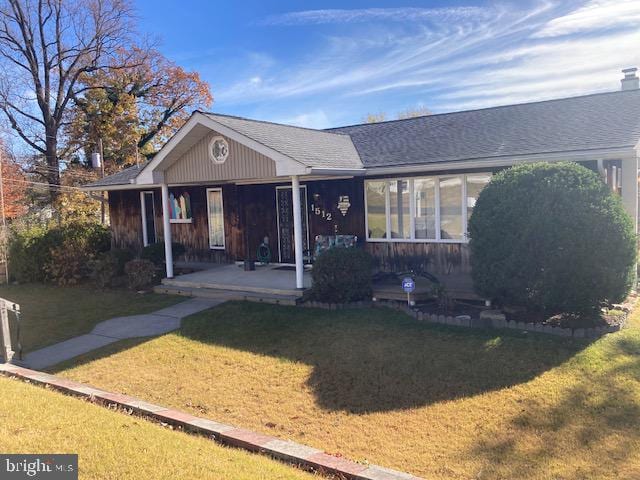 view of front of house with a porch and a front lawn