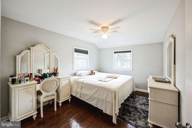 bedroom featuring ceiling fan, dark hardwood / wood-style flooring, and lofted ceiling