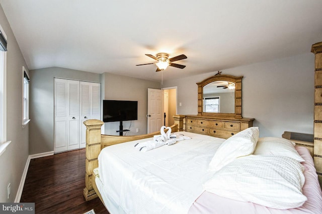 bedroom featuring ceiling fan, dark hardwood / wood-style flooring, lofted ceiling, and a closet