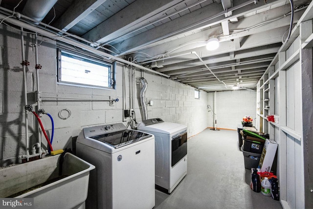 washroom with separate washer and dryer and sink