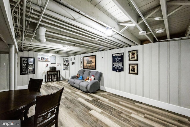 dining space featuring wood walls and wood-type flooring