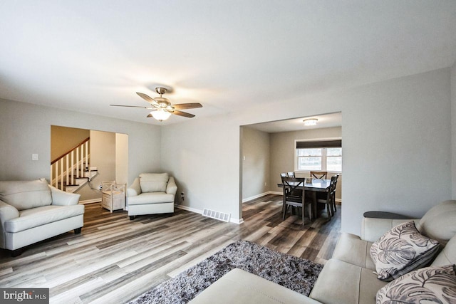 living room featuring ceiling fan and hardwood / wood-style floors