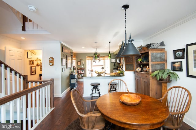 dining room with dark hardwood / wood-style flooring and ornamental molding