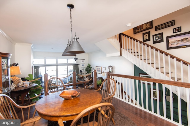 dining room featuring dark hardwood / wood-style flooring and ornamental molding