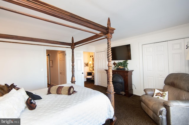 bedroom featuring crown molding and dark carpet