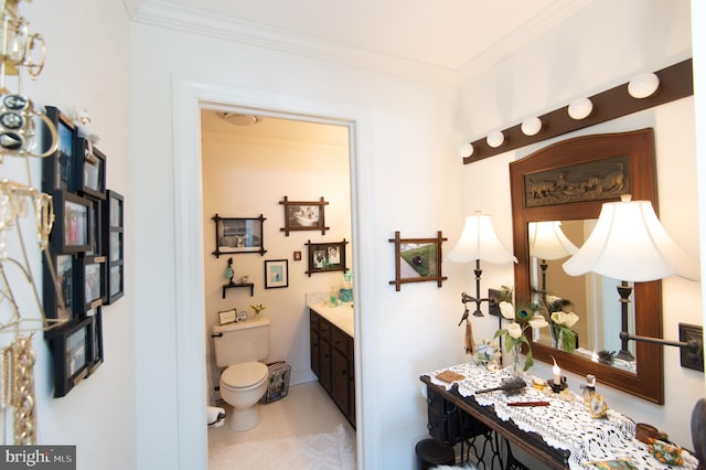 bathroom featuring vanity, toilet, and crown molding