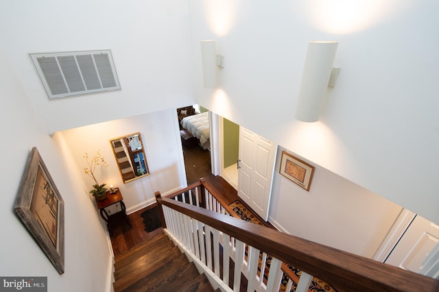 staircase with hardwood / wood-style flooring