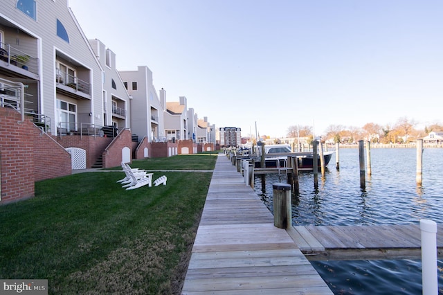 dock area featuring a lawn and a water view