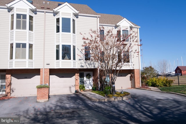 multi unit property featuring a garage