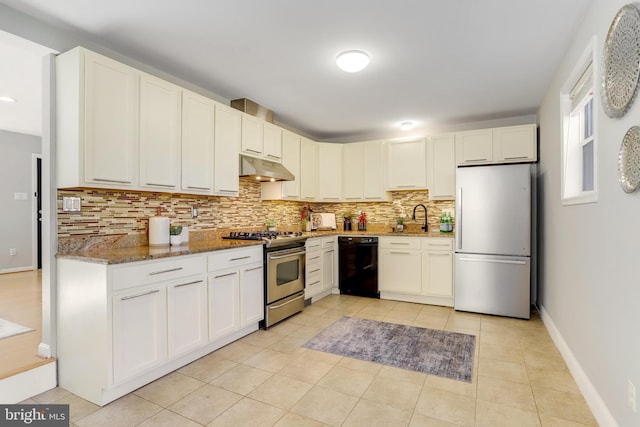 kitchen with white cabinetry, sink, dark stone counters, and appliances with stainless steel finishes