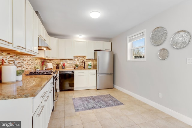 kitchen with decorative backsplash, white cabinets, light stone countertops, and appliances with stainless steel finishes