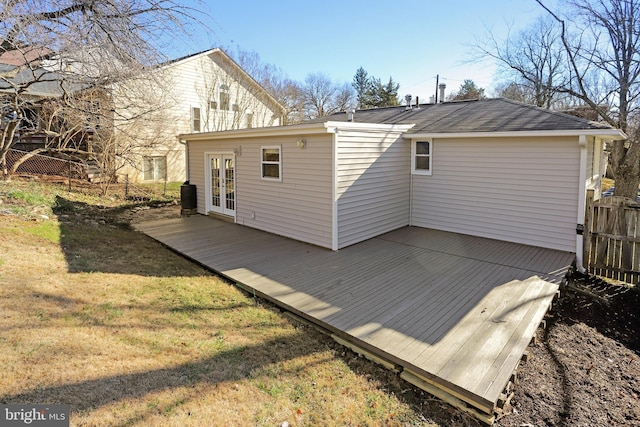 rear view of property with french doors and a lawn