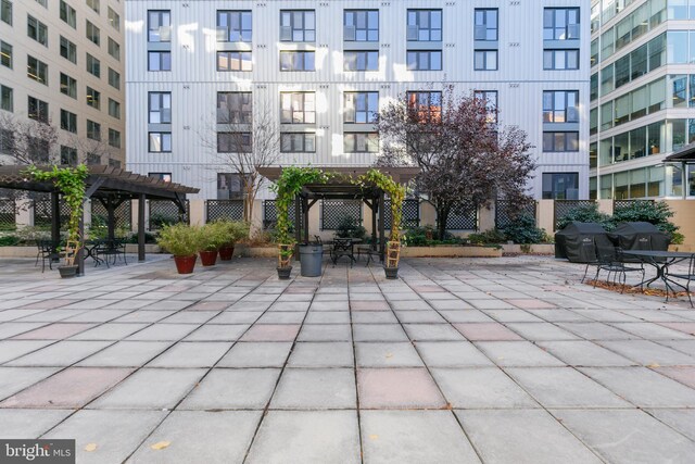 view of community with a pergola and a patio area