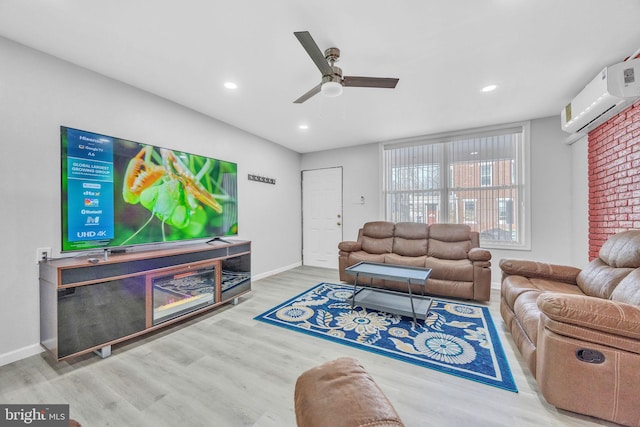 living room featuring a wall unit AC, ceiling fan, and hardwood / wood-style floors