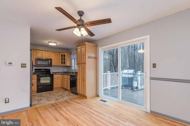 kitchen with ceiling fan, light hardwood / wood-style flooring, black appliances, and sink