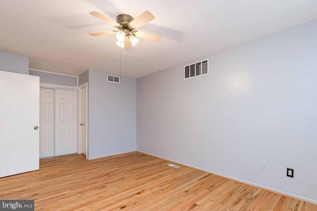 unfurnished bedroom featuring light wood-type flooring, a closet, and ceiling fan