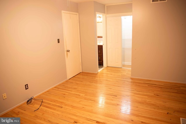 unfurnished room with light wood-type flooring