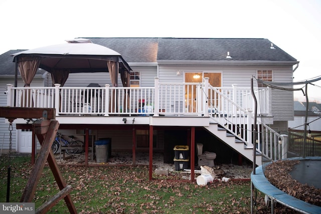 rear view of house featuring a gazebo and a deck