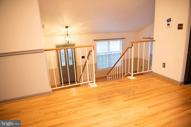 empty room featuring light hardwood / wood-style flooring and a chandelier