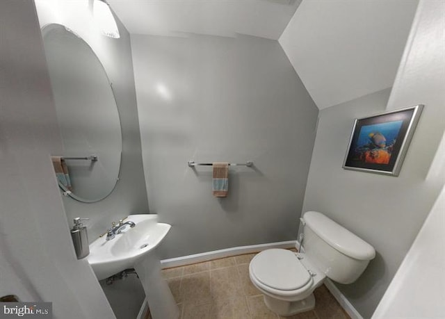 bathroom with toilet and vaulted ceiling