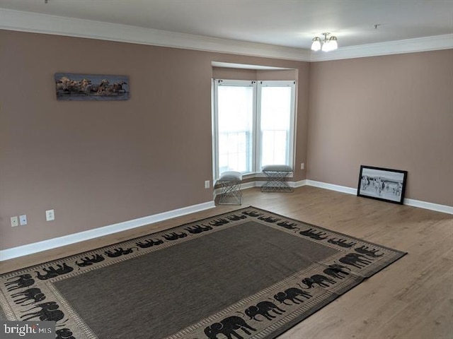 kitchen with wood-type flooring and crown molding