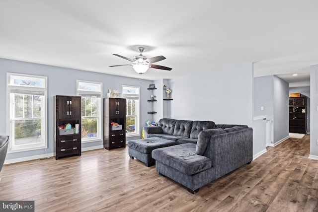 living room featuring ceiling fan and hardwood / wood-style flooring